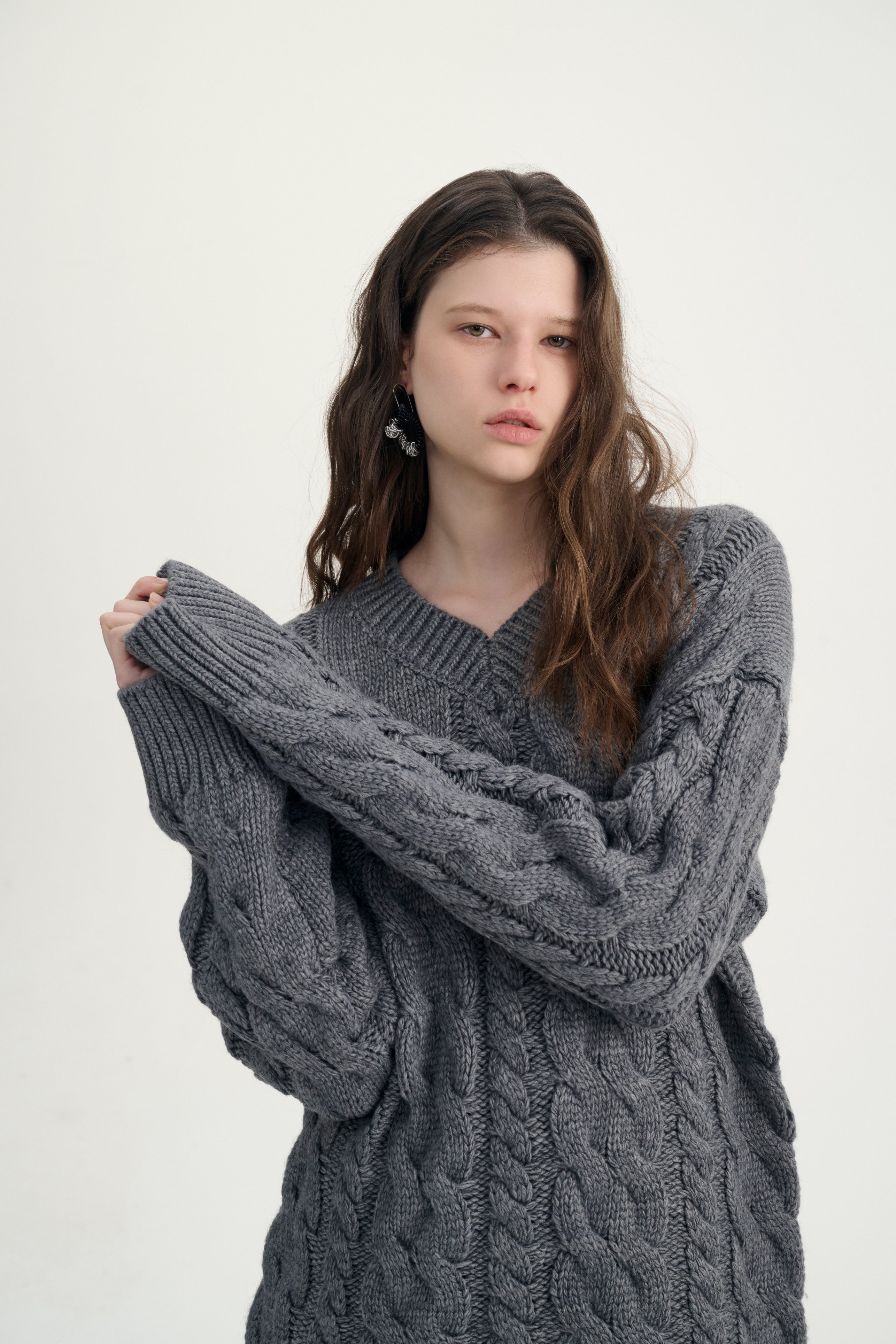 Cable knit fringed sweater